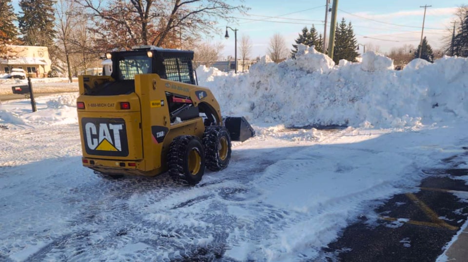 Cleaning Snow In A Parking Lot.